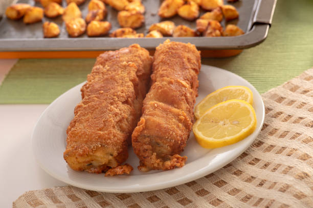 istock Fried ham roll wrapped in batter with American potatoes on a plate. 1292258408