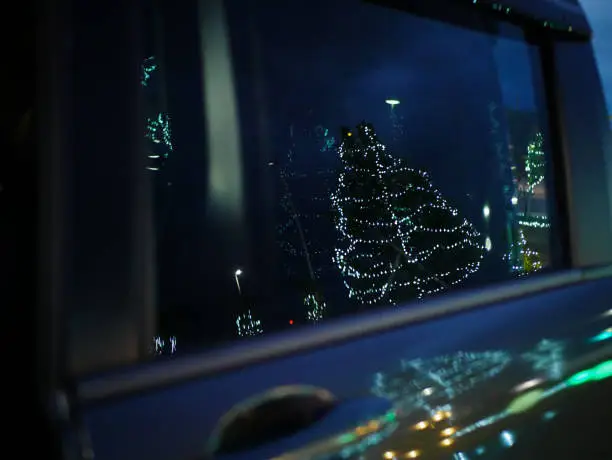 Photo of Christmas illuminations reflected in the car