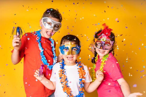 three kids celebrating carnival or new years eve at home - 12 13 years fotos imagens e fotografias de stock