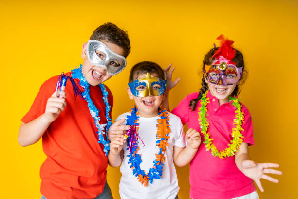 three kids celebrating carnival or new years eve at home - 12 13 years fotos imagens e fotografias de stock