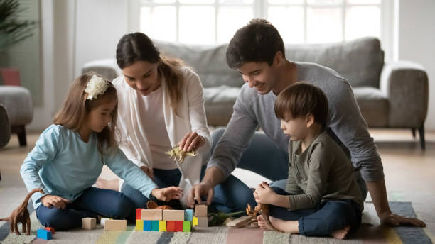 istock Happy parents and small kids playing at home 1292260699