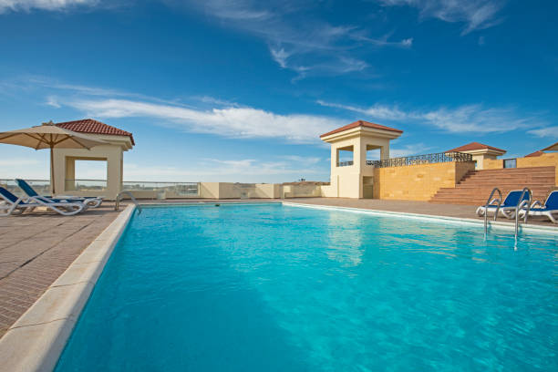 istock Rooftop swimming pool in a luxury tropical hotel resort 1292261902