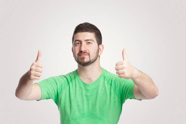 istock Portrait of handsome man giving thumbs up with both hands over white background 1292262012