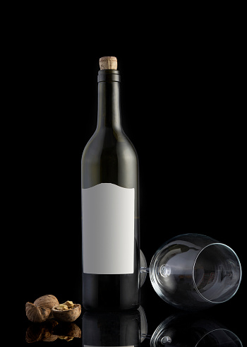 Red wine bottle on  wooden background.  Wine making and wine degustation concept.Toned image with copy space