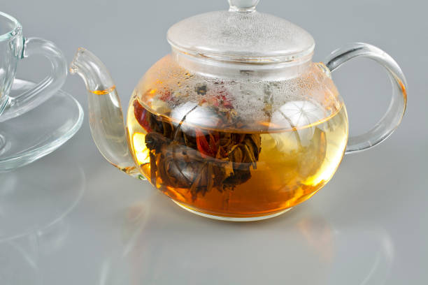 Exotic green flower bud tea in a glass teapot