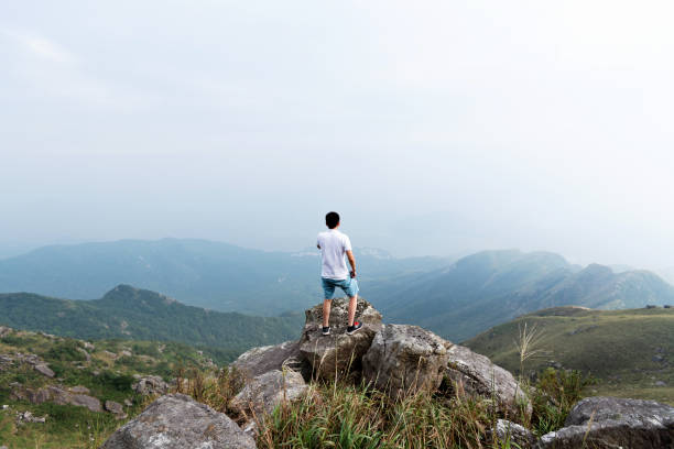istock Man standing on the top of mountain 1292266671