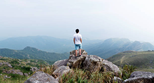 istock Man standing on the top of mountain 1292266725