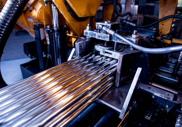 istock Automatic band saw machine with water coolant cutting metal pipes. 1292266763