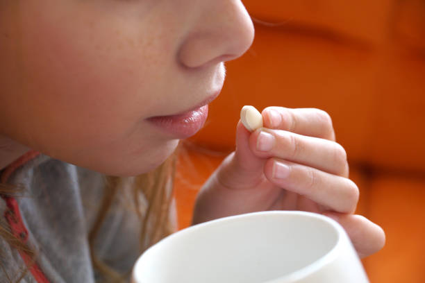 istock a girl takes a pill close up 1292278050