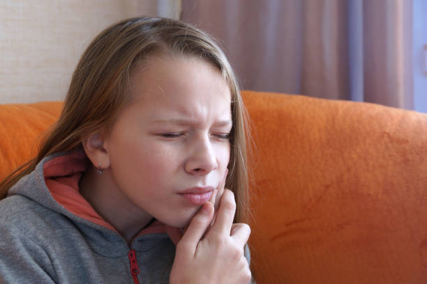 istock the girl has a toothache close up 1292278163