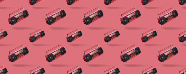 istock Seamless pattern with Vintage radio cassette recorder isolated over pink background.  retro technology 1292279076