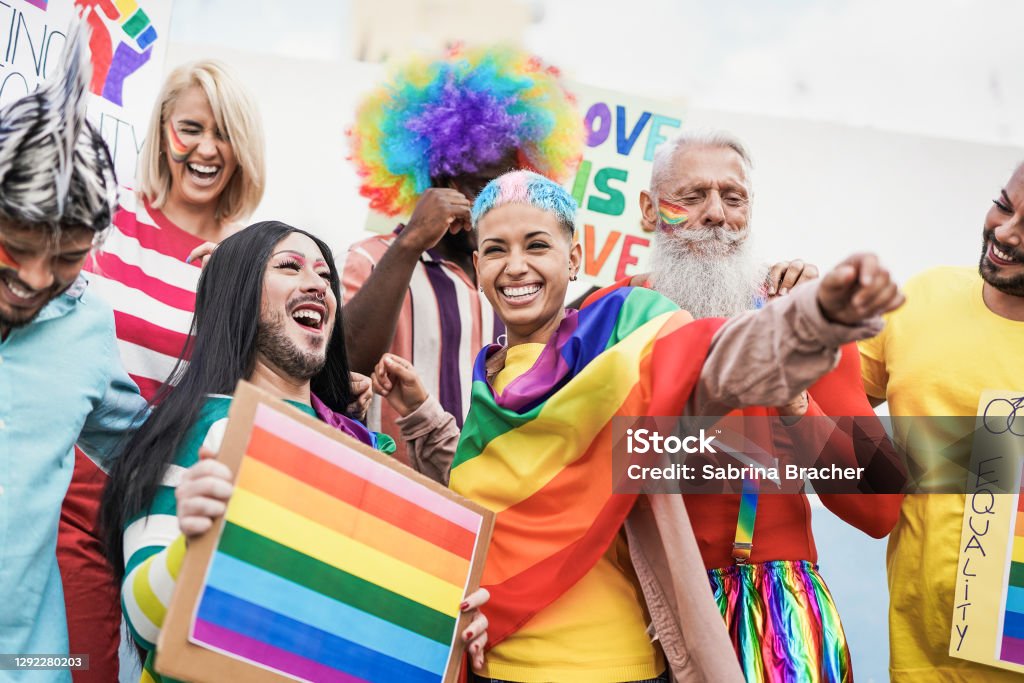 People from different generations have fun at gay pride parade with banner - Lgbt and homosexual love concept LGBTQIA Pride Event Stock Photo