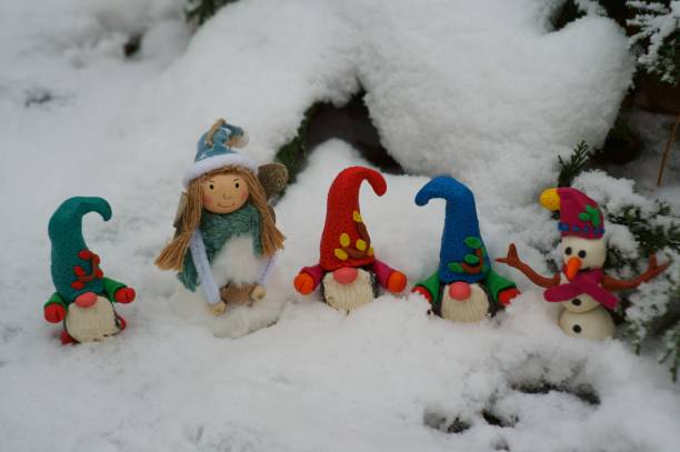 istock Figures of colorful dwarfs in a snowy forest. 1292280322