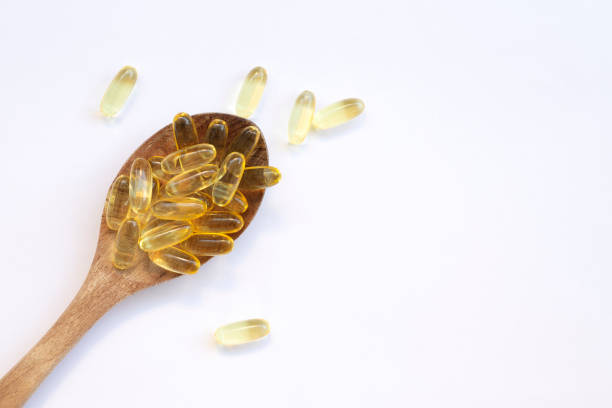 fish oil capsules in a spoon fish oil capsules in a spoon Soft Gel stock pictures, royalty-free photos & images