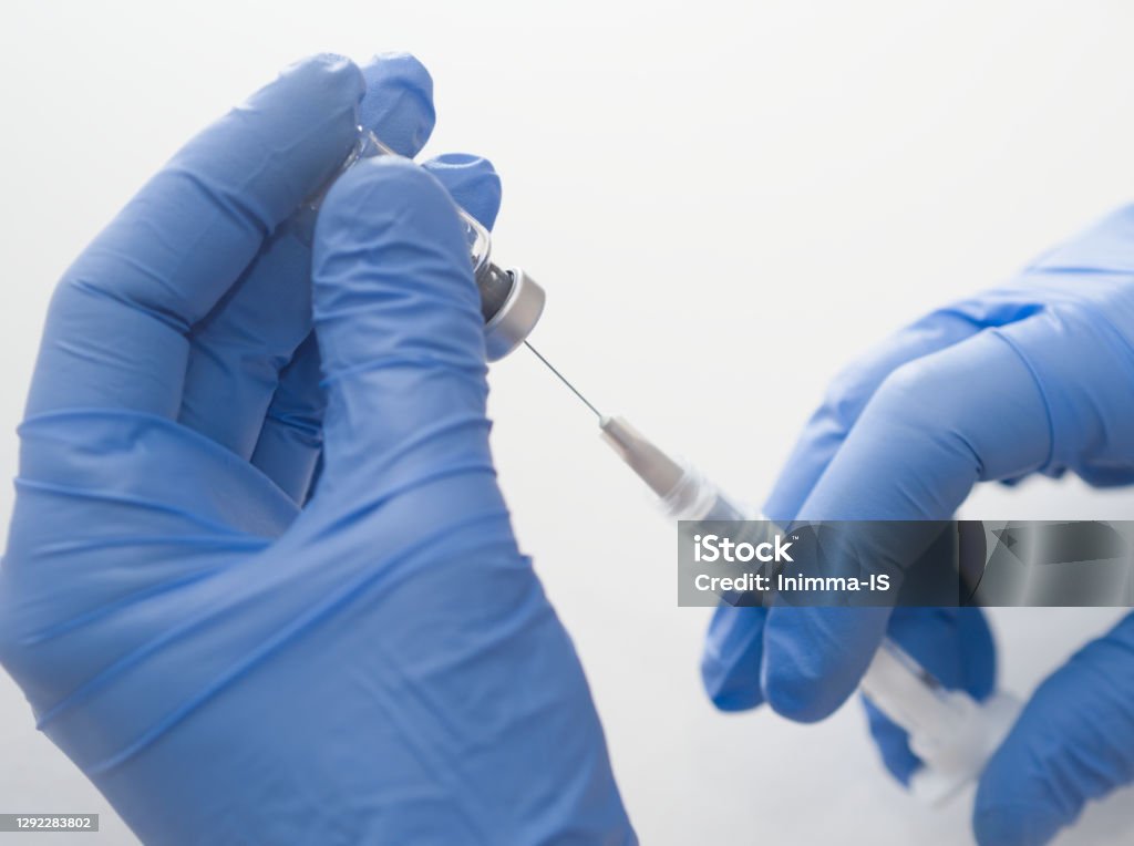Hand Using A Syringe Hands Holding Syringe And Vial Stock Photo - Download Image Now ...