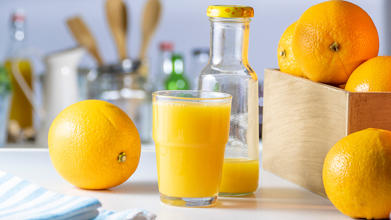 Orange Juice Bottle and Glass with Fruits