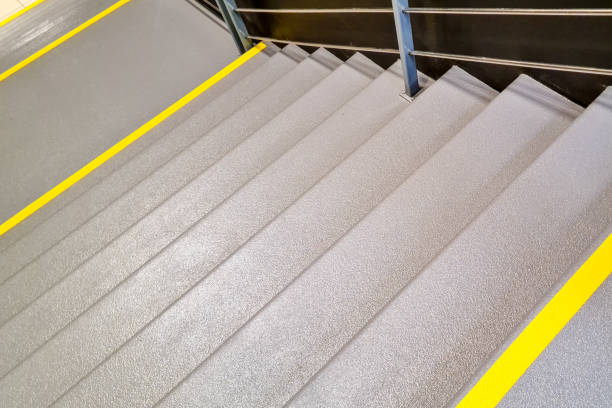 public building stairs with a yellow warning stripe yellow warning sign on stairs signifying a potential hazard, steep stairs and care to be taken when going up or down stairs caution step stock pictures, royalty-free photos & images