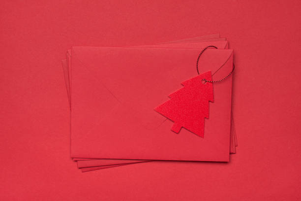 photo image flat lay view of pile heap stack of monochromatic envelopes with tag in shape of tree isolated red bright background - paper stack heap index card imagens e fotografias de stock