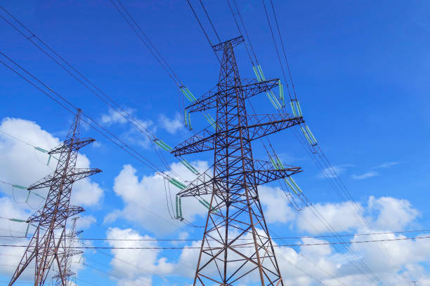 Power transmission lines against the blue sky stock photo