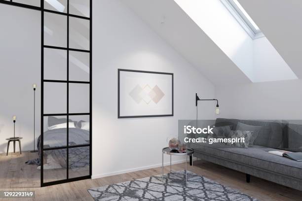 Modern Attic With A Horizontal Poster On A White Wall Between A Gray Sofa With A Coffee Table And A Glass Partition There Are A Roof Window And A Carpet On The Wooden Floor In The Room Stock Photo - Download Image Now