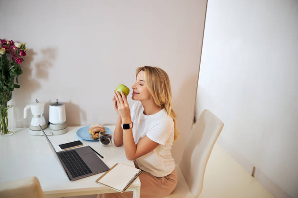 istock Relaxed blonde woman going to eat fresh apple 1292293834