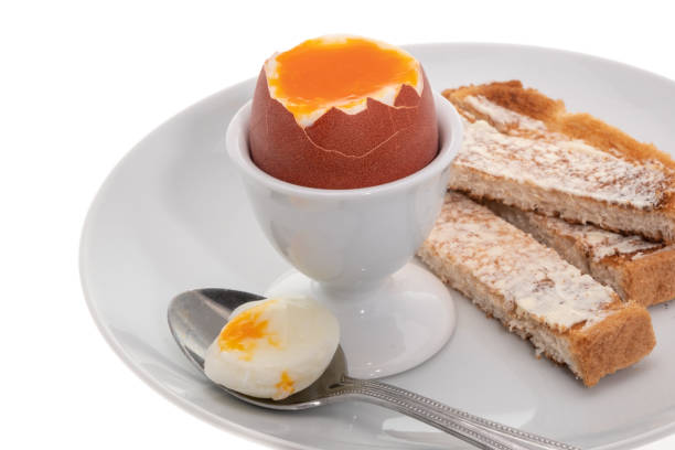 Soft boiled egg with toasted and buttered bread slices