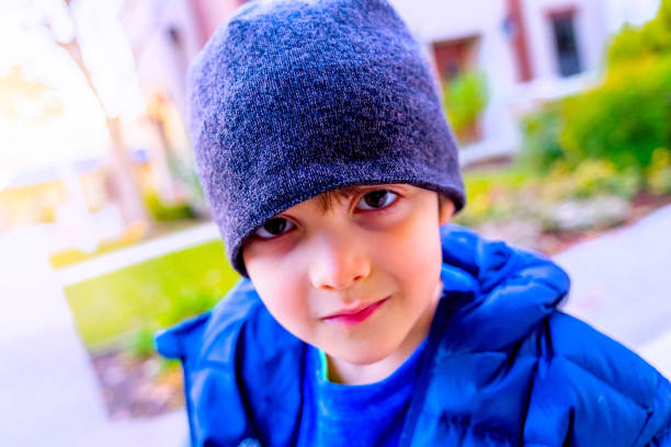 istock Smiling pensive little boy looking at the camera wearing a toque hat 1292296242