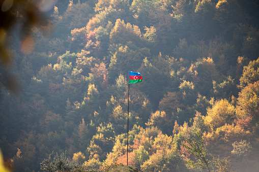 Azerbaijan flag,Waving flag on the mountain. National flag of Azerbaijan on strong wind in the sunny day. Outdoor nature shot