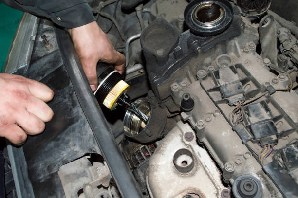 istock Mechanic changing the oil filter 1292297731