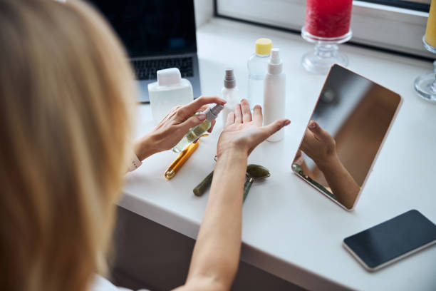 istock Young womann is putting moisturizing on hand 1292298379