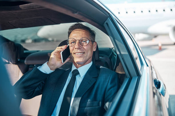 istock Happy businessman making call after landing by plane 1292299905