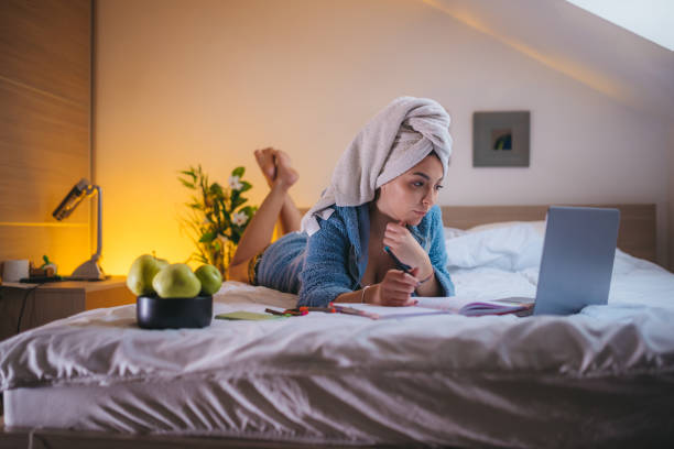 istock Woman working from home in bed during the quarantine 1292300166