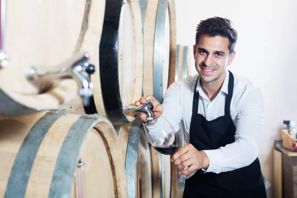 istock Seller pouring wine in cellar 1292300313