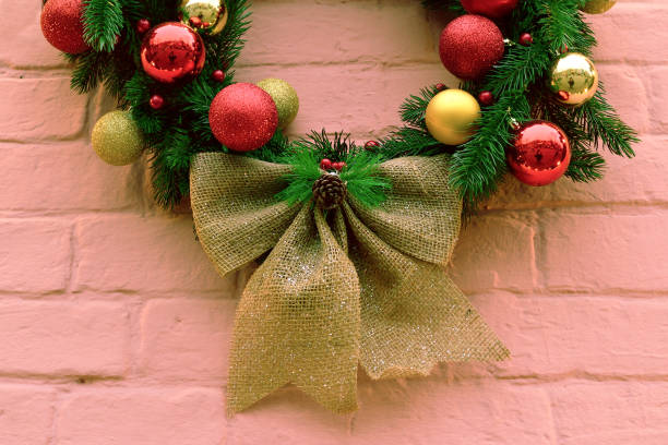 istock christmas wreath on a pink brick wall 1292300973
