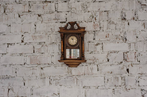 istock Old Vintage wood clock on the brick wall 1292301137