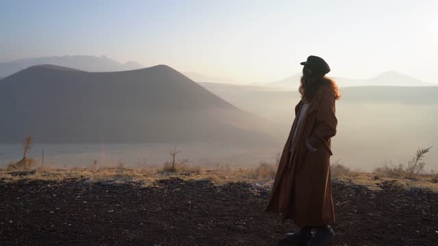 Woman standing and looking at volcano