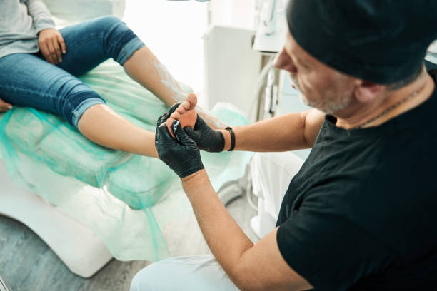 istock Attentive bearded podiatrist doing his job professionally 1292304497