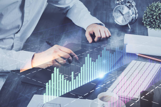 istock Double exposure of man's hands holding and using a phone and financial graph drawing. Analysis concept. 1292310077