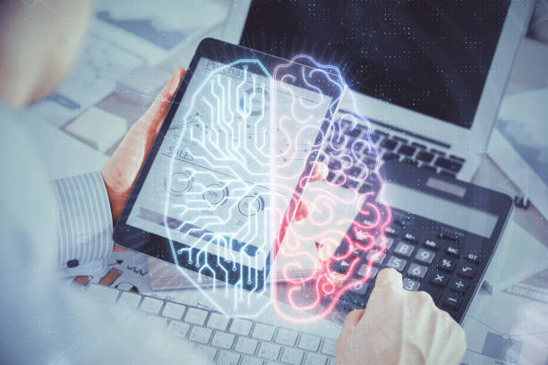 istock Double exposure of man's hand holding and using a digital device and brain hologram drawing. Data concept. 1292310762