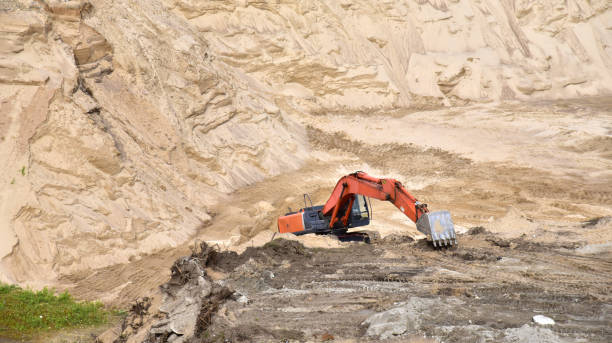 istock Red Crawler Excavator Works Excavating In A Sandy Mining Quarry 1292311475