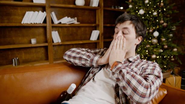 istock Alcohol addiction at young age. Caucasian male cannot stop drinking alcohol, drunken lonely male drinks wine from bottle. Loneliness, depression and alcoholism during Christmas and New Year holidays 1292314523