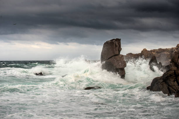 istock Powerful waves crashes in rocky coastline 1292315447