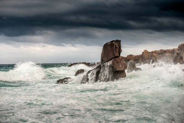 istock Powerful waves crashes in rocky coastline 1292315448