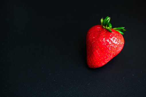 Close up of fresh strawberries on black background