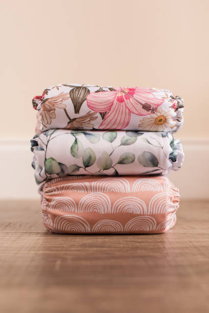 istock A Girly Stack of Modern & Colorful Reusable Cloth Diapers with a Neutral Background in Bright Natural Light 1292319778