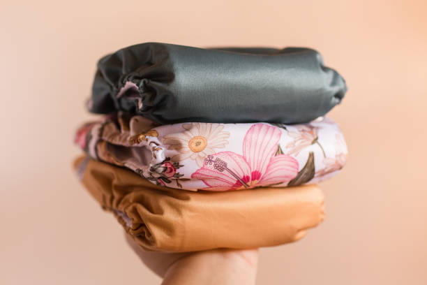 istock A Woman Holding a Stack of Modern Neutral-Colored Reusable Cloth Diapers with a Neutral Background in Bright Natural Light 1292320399