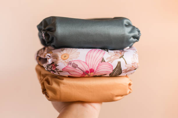 istock A Woman Holding a Stack of Modern Neutral-Colored Reusable Cloth Diapers with a Neutral Background in Bright Natural Light 1292320521