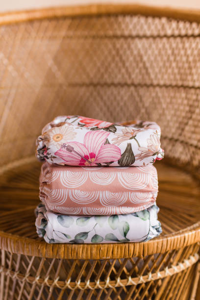 istock A Girly Stack of Modern & Colorful Reusable Cloth Diapers with a Neutral Background in Bright Natural Light 1292320807