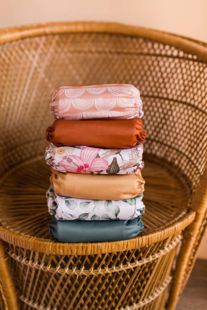 istock A Girly Stack of Modern & Colorful Reusable Cloth Diapers with a Neutral Background in Bright Natural Light 1292321571