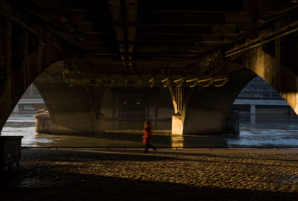 istock blurry pedestrian walking on cobblestones under a bridge 1292321732